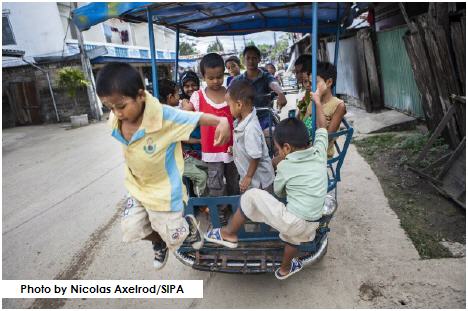 Children going to school via somlot, a motorcycle rickshaw in Mae Sot, Thailand