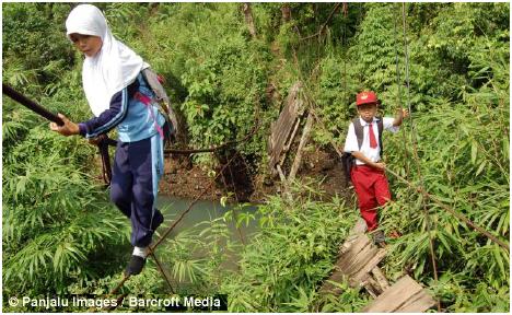 During the wet season, some children decide not to make the crossing for fear of falling in the flowing river below