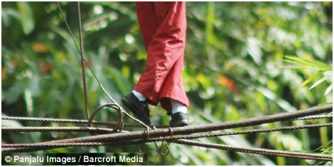 The children risk a 30 foot drop as they cross the river each morning before school in Pandang